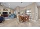 Inviting dining area with wood table, seating for four, tile floors, and ample natural light at 5020 Linkside Dr, Las Vegas, NV 89130