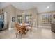 Cozy dining area features tile floors, natural light, and wood table with seating for four at 5020 Linkside Dr, Las Vegas, NV 89130