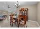 Formal dining room featuring elegant table, chairs, and china cabinet under decorative lighting at 5020 Linkside Dr, Las Vegas, NV 89130