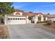 Inviting single-story home with a well-manicured lawn and spacious driveway at 5020 Linkside Dr, Las Vegas, NV 89130