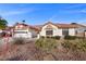 Charming single-story home with a tile roof, low-maintenance landscaping, and a two-car garage, bathed in sunlight at 5020 Linkside Dr, Las Vegas, NV 89130