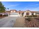 Beautiful single-story home featuring a tile roof, desert landscaping, and an attached two-car garage at 5020 Linkside Dr, Las Vegas, NV 89130