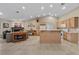 Open kitchen features tile floors, oak cabinets, a gas range and flows into the living room at 5020 Linkside Dr, Las Vegas, NV 89130