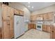 Kitchen offers oak cabinets, gas range, stainless steel dishwasher and spacious layout at 5020 Linkside Dr, Las Vegas, NV 89130