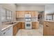 Bright kitchen showcases ample oak cabinetry, a gas range, and neutral countertops at 5020 Linkside Dr, Las Vegas, NV 89130