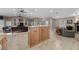 Spacious living room features tile floors, oak cabinetry and opens to an additional living area at 5020 Linkside Dr, Las Vegas, NV 89130