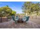Charming patio area with comfortable seating around a brick fire pit, perfect for outdoor gatherings at 5020 Linkside Dr, Las Vegas, NV 89130