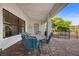 Cozy covered patio featuring string lights, a dining area, and a view of the serene backyard at 5020 Linkside Dr, Las Vegas, NV 89130