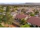 Backyard view of a single-Gathering home with patio seating, a fenced yard, and mature trees in a residential community at 5020 Linkside Dr, Las Vegas, NV 89130
