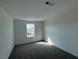 Comfortable bedroom featuring soft carpeting and a bright window at 5163 Capucina St # Lot 3, Las Vegas, NV 89122