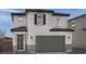 Charming two-story home featuring a gray garage door, tile roof, and decorative shutters, enhancing curb appeal at 5163 Capucina St # Lot 3, Las Vegas, NV 89122