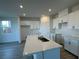 Modern kitchen featuring white cabinets, a stylish island, and stainless steel appliances at 5163 Capucina St # Lot 3, Las Vegas, NV 89122