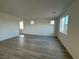 Spacious living room with hardwood floors and multiple windows, allowing for plenty of natural light at 5163 Capucina St # Lot 3, Las Vegas, NV 89122
