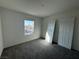 A cozy carpeted bedroom is brightened by a window showcasing a neighborhood view at 5175 Capucina St # Lot 5, Las Vegas, NV 89122