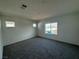 Bright bedroom with neutral carpet, large windows offering natural light at 5175 Capucina St # Lot 5, Las Vegas, NV 89122