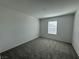 Cozy bedroom with neutral carpet and a window providing natural light at 5175 Capucina St # Lot 5, Las Vegas, NV 89122