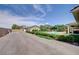 Expansive backyard featuring a pool, green landscaping, and detached garage; perfect for outdoor activities at 5500 Santovito St, Pahrump, NV 89061