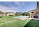 Expansive backyard showcases a sparkling pool, covered patio, and lush greenery, ideal for outdoor enjoyment at 5500 Santovito St, Pahrump, NV 89061