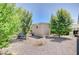 Backyard featuring a small building, trees, and gravel ground cover at 5500 Santovito St, Pahrump, NV 89061
