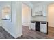 Elegant bar area with custom cabinets, wine rack, under-counter beverage fridge, and granite countertops at 5500 Santovito St, Pahrump, NV 89061
