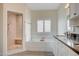 A luxurious bathroom featuring a shower, large soaking tub, and a double vanity at 5500 Santovito St, Pahrump, NV 89061