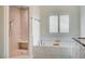 A luxurious bathroom with a tiled shower, large soaking tub, and bright window at 5500 Santovito St, Pahrump, NV 89061