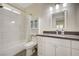 Updated bathroom featuring sleek vanity, decorative mirror, and tiled shower-tub combo at 5500 Santovito St, Pahrump, NV 89061