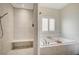 Bright bathroom showcasing tiled shower, soaking tub, and modern hardware at 5500 Santovito St, Pahrump, NV 89061