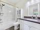 Bathroom with white marble tiled shower and dark countertops at 5500 Santovito St, Pahrump, NV 89061