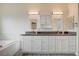 Bright bathroom featuring double vanity, a soaking tub, and modern lighting at 5500 Santovito St, Pahrump, NV 89061