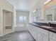 Bright bathroom featuring dual sinks, a soaking tub, and walk-in shower at 5500 Santovito St, Pahrump, NV 89061