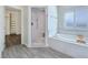 Luxurious bathroom with tiled shower, large tub and access to a closet at 5500 Santovito St, Pahrump, NV 89061