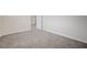 Spacious bedroom featuring neutral carpet, a white door and baseboards, and light, neutral paint at 5500 Santovito St, Pahrump, NV 89061