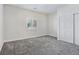 Bright bedroom with gray carpet, closet, and window with shutters at 5500 Santovito St, Pahrump, NV 89061