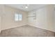 Well-lit bedroom with a ceiling fan and built-in shelving unit at 5500 Santovito St, Pahrump, NV 89061