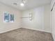 Cozy bedroom features neutral carpet, a ceiling fan, and a bright window with shutters at 5500 Santovito St, Pahrump, NV 89061