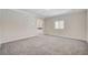 Spacious bedroom with neutral carpet, modern wall clock, and bright window at 5500 Santovito St, Pahrump, NV 89061