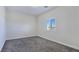 Cozy bedroom with neutral carpeting, white trim, and a window offering natural light and views at 5500 Santovito St, Pahrump, NV 89061