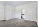 Carpeted bedroom with closet and doorway to the bathroom at 5500 Santovito St, Pahrump, NV 89061