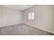 A neutral bedroom with a window fitted with white shutters at 5500 Santovito St, Pahrump, NV 89061