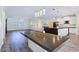 Expansive dining area showcases modern fixtures, black countertops, and seamless transition to living spaces at 5500 Santovito St, Pahrump, NV 89061