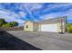 Detached garage exterior with asphalt driveway and basketball hoop and backboard at 5500 Santovito St, Pahrump, NV 89061