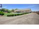 Well-maintained exterior featuring a spacious yard, covered patio, and ample parking space for multiple vehicles at 5500 Santovito St, Pahrump, NV 89061