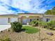 Attractive single-story home with a three-car garage, manicured landscaping, and a welcoming front entrance at 5500 Santovito St, Pahrump, NV 89061