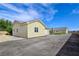 Spacious detached garage with a tile roof, asphalt driveway, and well-maintained landscaping at 5500 Santovito St, Pahrump, NV 89061