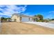 Charming single-story home with a three-car garage, gated driveway, and desert landscaping at 5500 Santovito St, Pahrump, NV 89061