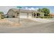 Charming single-story home with a tile roof, multi-car garage, stone accents, and desert landscaping at 5500 Santovito St, Pahrump, NV 89061