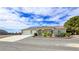 Inviting single-story home with a long driveway, three-car garage, and well-maintained landscaping at 5500 Santovito St, Pahrump, NV 89061