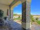 Welcoming front porch with stone pillars and outdoor seating area, perfect for enjoying the view at 5500 Santovito St, Pahrump, NV 89061
