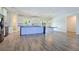 Bright, open kitchen featuring a large island, stainless steel appliances, and sleek, white cabinets at 5500 Santovito St, Pahrump, NV 89061